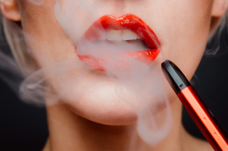 woman vaping with red lipstick